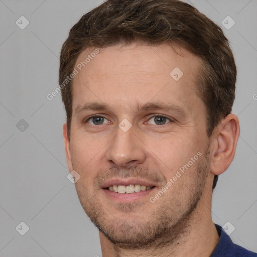 Joyful white adult male with short  brown hair and brown eyes