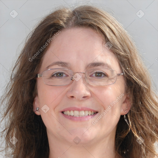 Joyful white adult female with long  brown hair and blue eyes