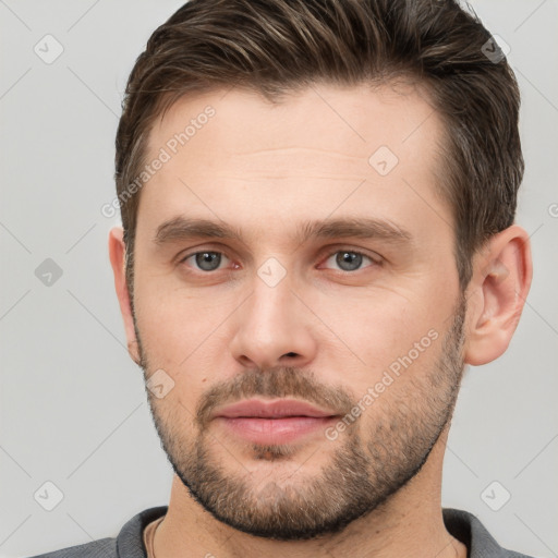 Joyful white young-adult male with short  brown hair and brown eyes