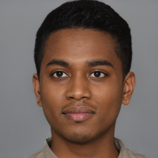 Joyful black young-adult male with short  black hair and brown eyes