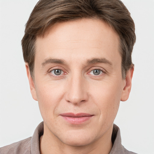 Joyful white adult male with short  brown hair and grey eyes