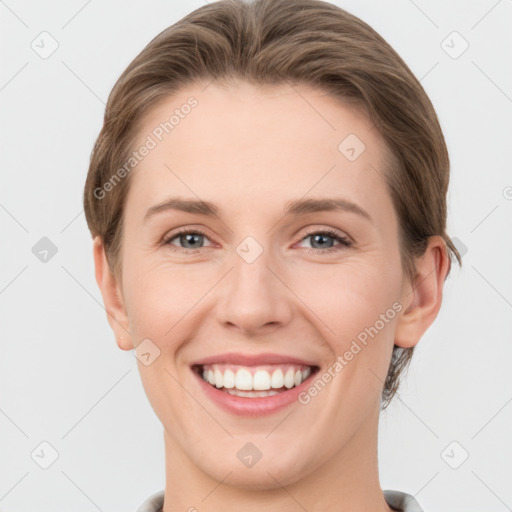 Joyful white young-adult female with short  brown hair and grey eyes