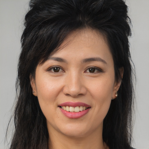Joyful asian young-adult female with long  brown hair and brown eyes