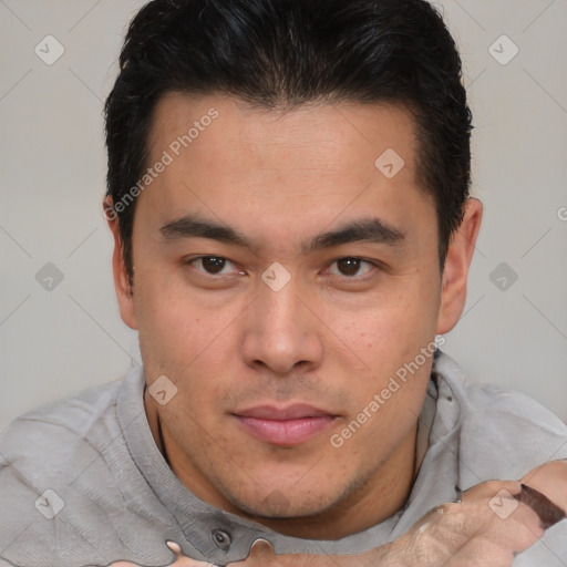 Joyful asian young-adult male with short  brown hair and brown eyes