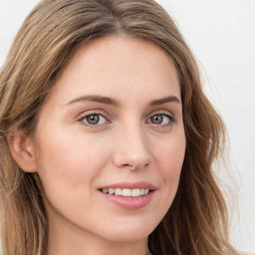 Joyful white young-adult female with long  brown hair and green eyes