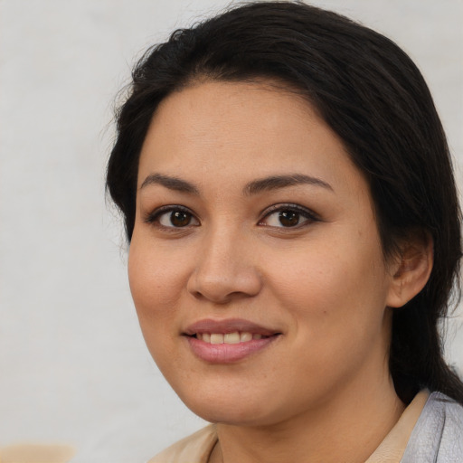 Joyful latino young-adult female with medium  black hair and brown eyes