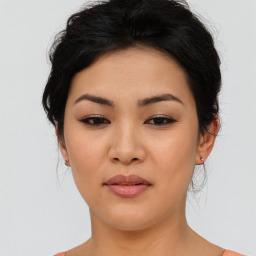 Joyful asian young-adult female with medium  black hair and brown eyes