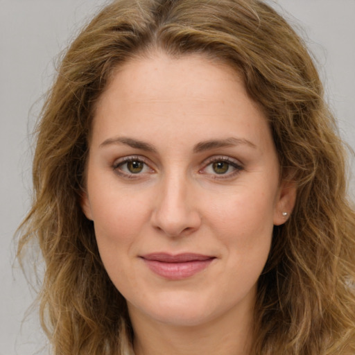 Joyful white young-adult female with long  brown hair and green eyes