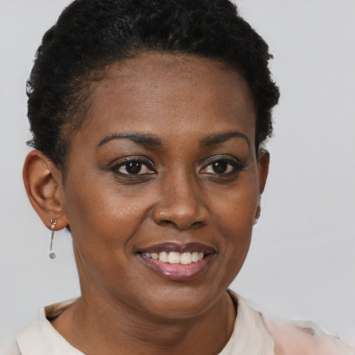 Joyful black young-adult female with short  brown hair and brown eyes