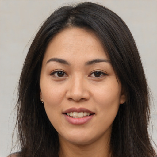 Joyful white young-adult female with long  brown hair and brown eyes