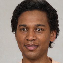 Joyful latino adult male with short  black hair and brown eyes