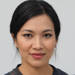 Joyful asian young-adult female with medium  brown hair and brown eyes