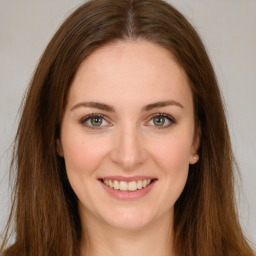 Joyful white young-adult female with long  brown hair and green eyes