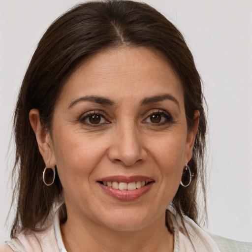 Joyful white adult female with medium  brown hair and brown eyes