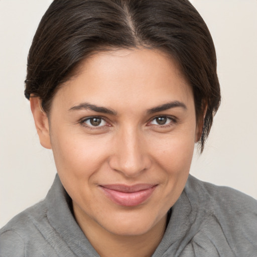 Joyful white young-adult female with short  brown hair and brown eyes