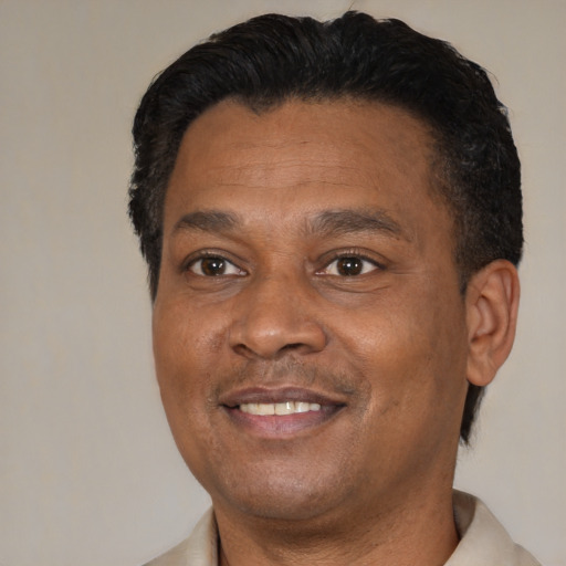 Joyful latino adult male with short  black hair and brown eyes