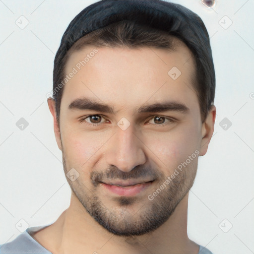 Joyful white young-adult male with short  black hair and brown eyes