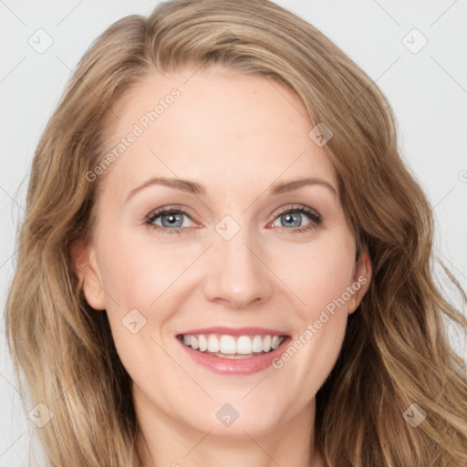 Joyful white young-adult female with long  brown hair and blue eyes