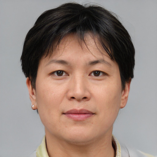 Joyful asian adult female with short  brown hair and brown eyes