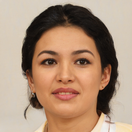 Joyful latino young-adult female with medium  brown hair and brown eyes