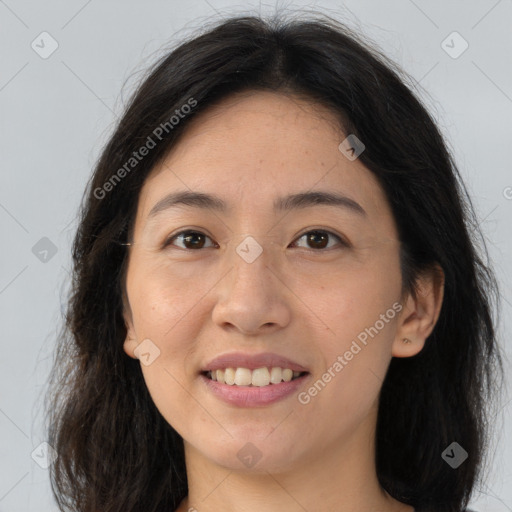 Joyful asian young-adult female with long  brown hair and brown eyes