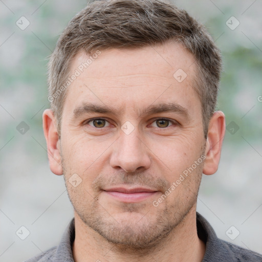 Joyful white adult male with short  brown hair and grey eyes