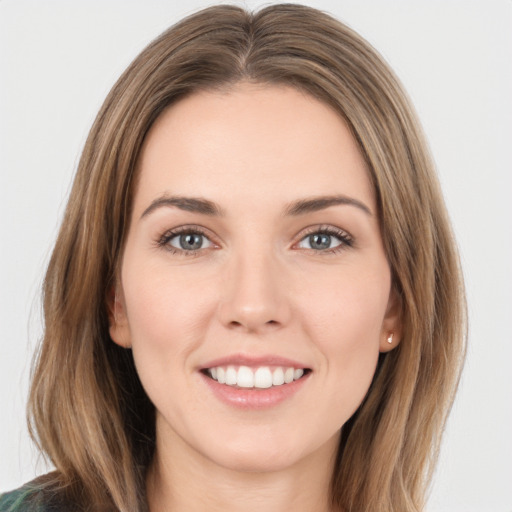 Joyful white young-adult female with medium  brown hair and green eyes