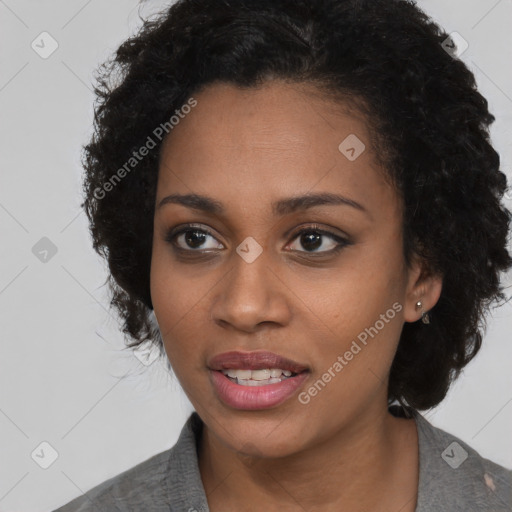 Joyful black young-adult female with medium  black hair and brown eyes