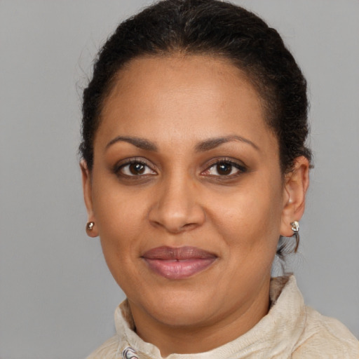 Joyful black adult female with short  brown hair and brown eyes