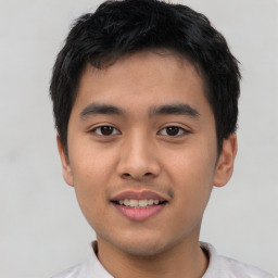 Joyful asian young-adult male with short  black hair and brown eyes