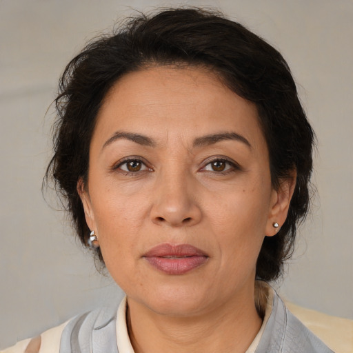 Joyful latino adult female with medium  brown hair and brown eyes