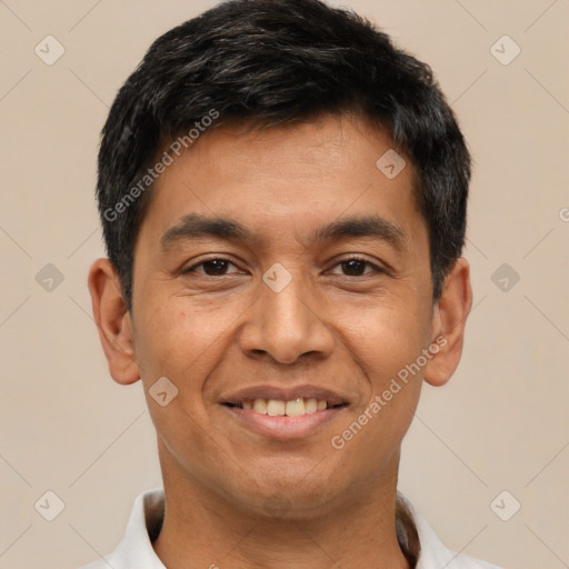 Joyful latino adult male with short  black hair and brown eyes