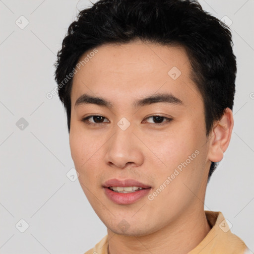 Joyful asian young-adult male with short  black hair and brown eyes