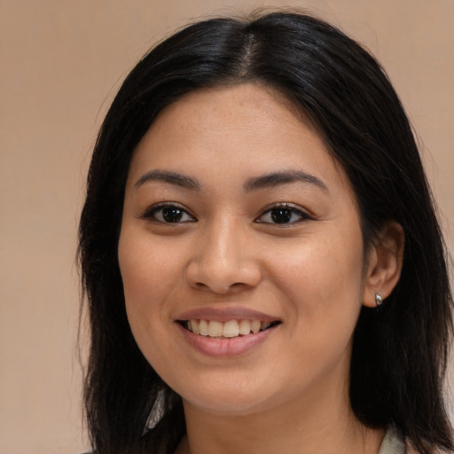 Joyful asian young-adult female with long  brown hair and brown eyes