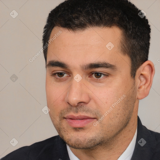 Joyful white young-adult male with short  black hair and brown eyes