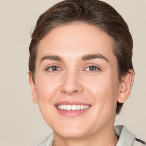 Joyful white young-adult female with short  brown hair and brown eyes