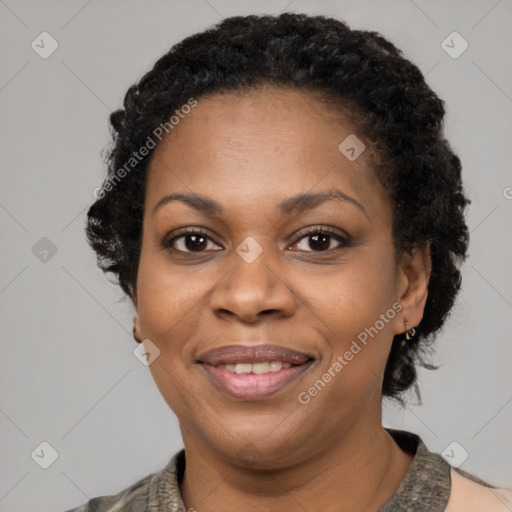 Joyful black adult female with short  black hair and brown eyes