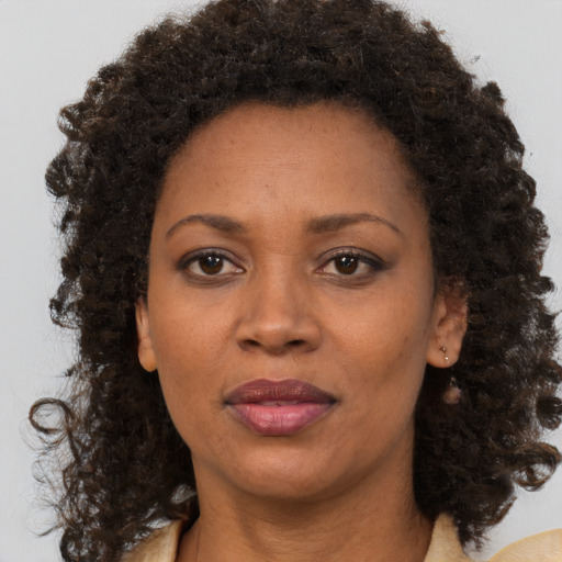 Neutral black adult female with medium  brown hair and brown eyes