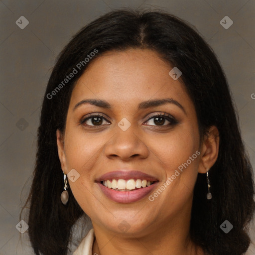 Joyful black young-adult female with long  brown hair and brown eyes