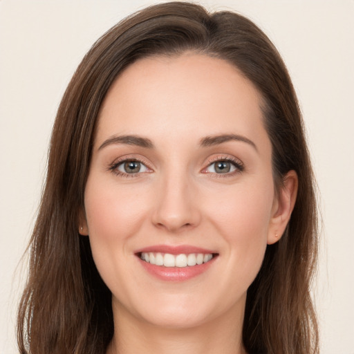 Joyful white young-adult female with long  brown hair and grey eyes