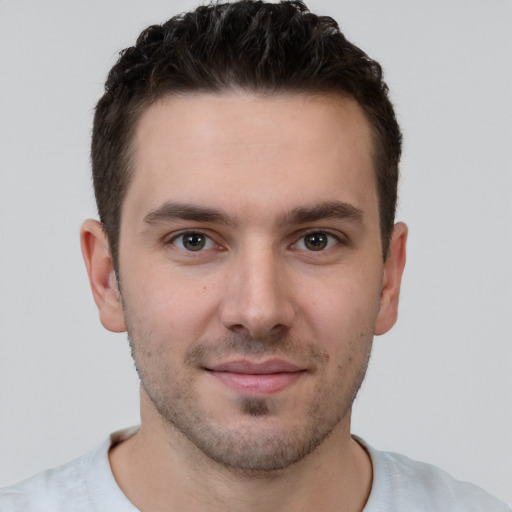 Joyful white young-adult male with short  brown hair and brown eyes