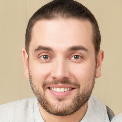 Joyful white young-adult male with short  brown hair and brown eyes