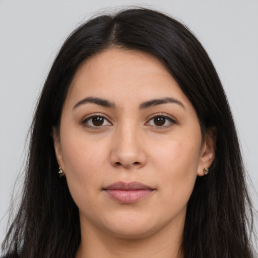 Joyful latino young-adult female with long  brown hair and brown eyes