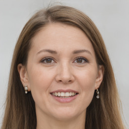 Joyful white young-adult female with long  brown hair and grey eyes