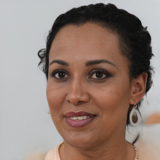 Joyful black young-adult female with medium  black hair and brown eyes