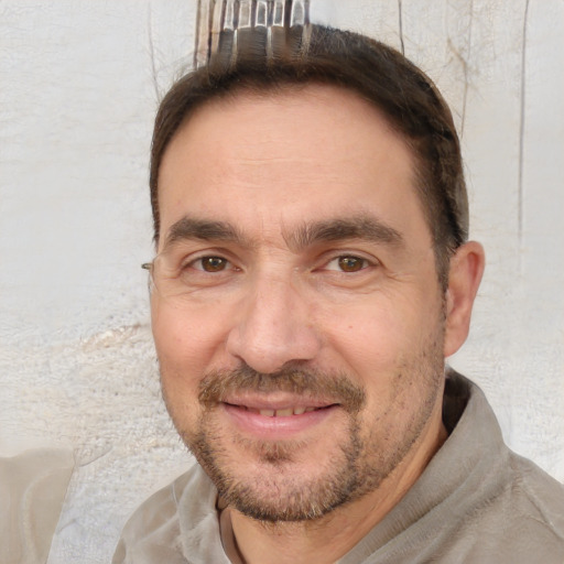 Joyful white adult male with short  brown hair and brown eyes