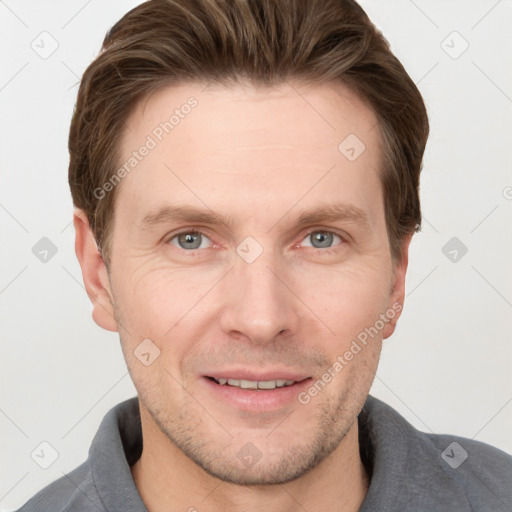 Joyful white adult male with short  brown hair and grey eyes