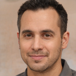 Joyful white adult male with short  brown hair and brown eyes