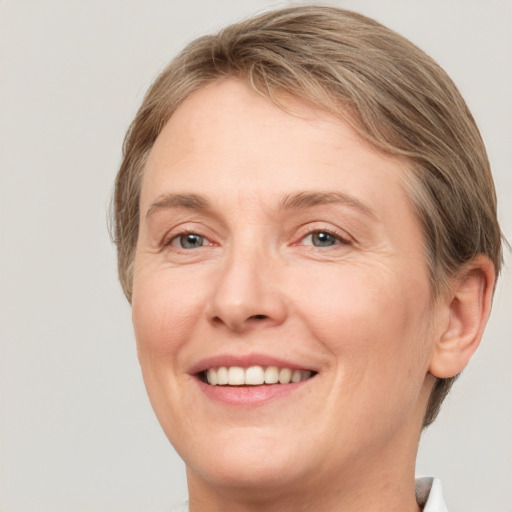 Joyful white adult female with short  brown hair and grey eyes