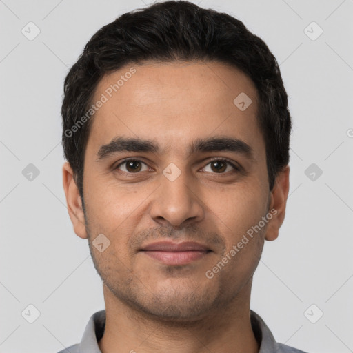 Joyful latino young-adult male with short  black hair and brown eyes